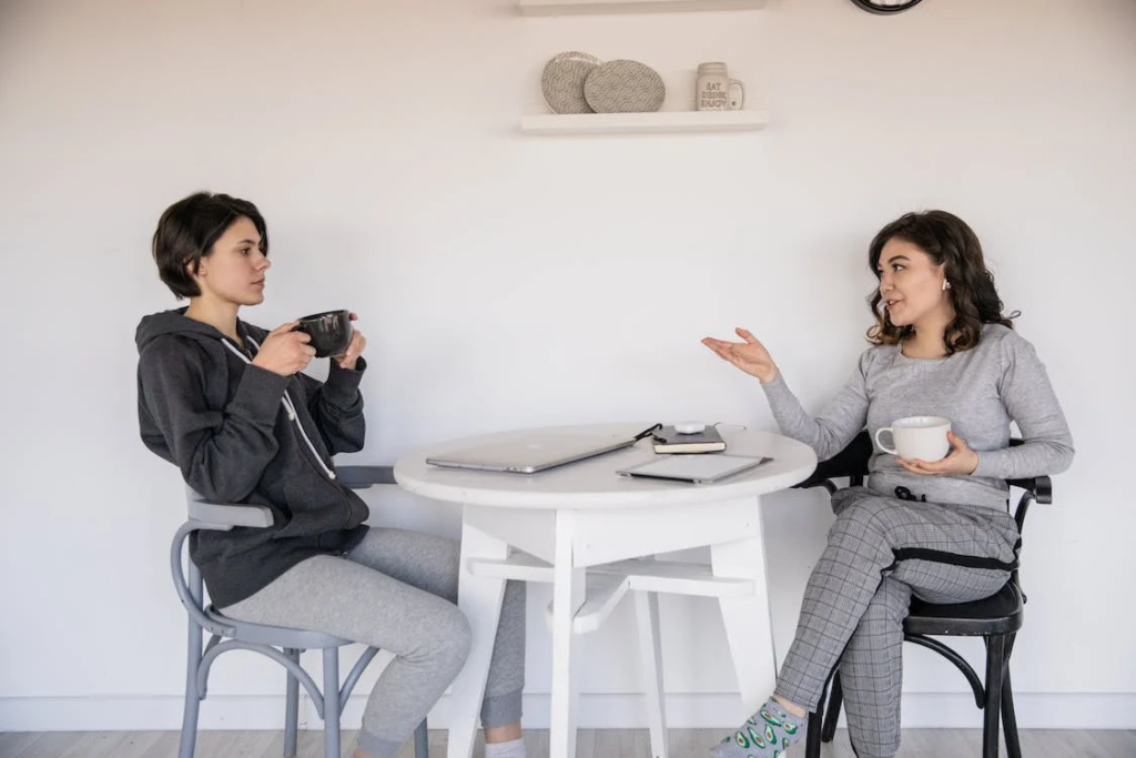 Two people in conversation over coffee