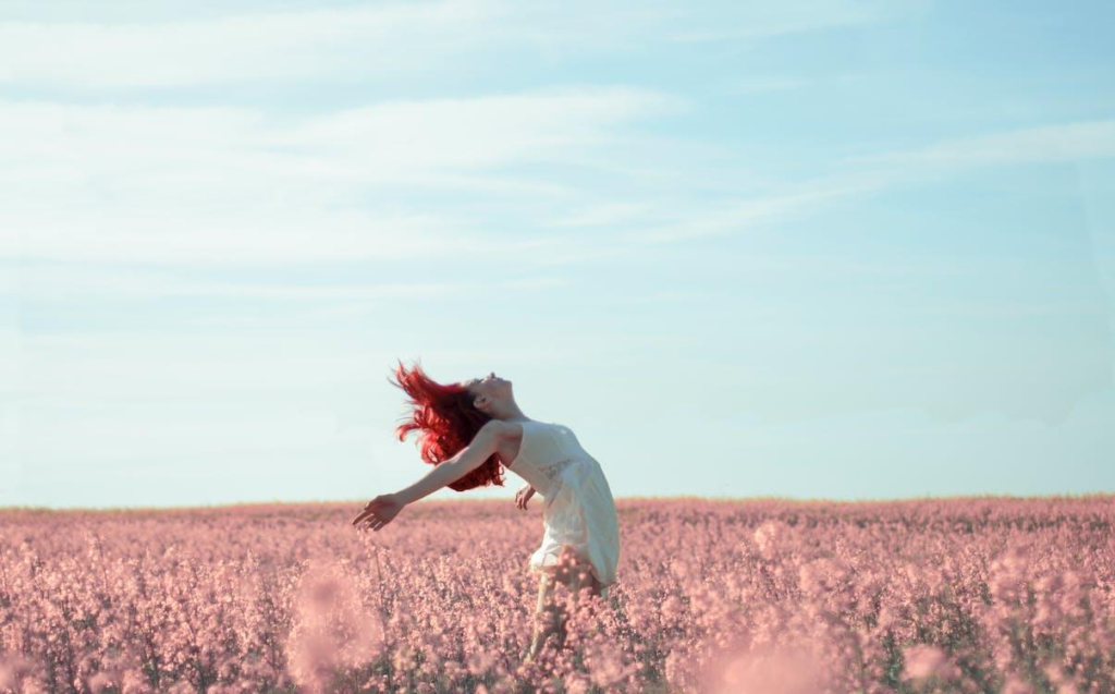 Woman feeling free in a field of flowers